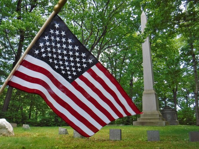 A U.S. flag at Brattleboro’s Morningside Cemetery waves near a memorial &mdash; once the state’s tallest &mdash; for the late Vermont Gov. Levi K. Fuller. 