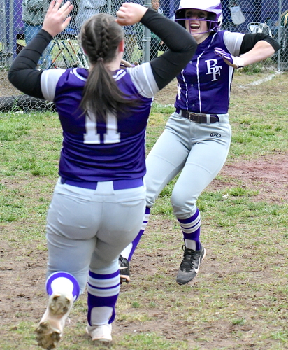 Bellows Falls baserunner Riley Haskell, right, is greeted by teammate Aliya Farmer after Haskell scored the winning run in a 3-2 victory over Green Mountain in a Division II softball quarterfinal on June 3 in Westminster.